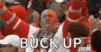 Man With Red And White Face Paint In Crowd Saying Buck Up GIF