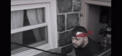 Man With Red Bandana Looking Out Window GIF