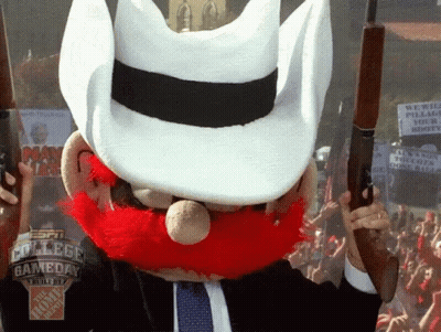 Man With Red Beard And White Hat Holding Two Guns GIF