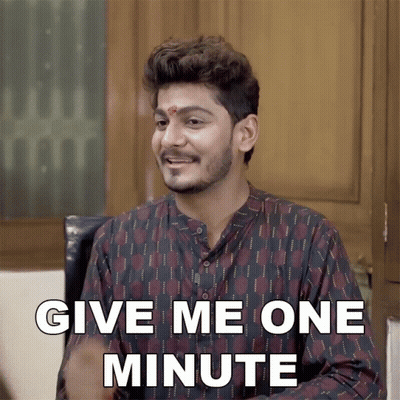 Man With Red Dot Saying Give Me One Minute GIF