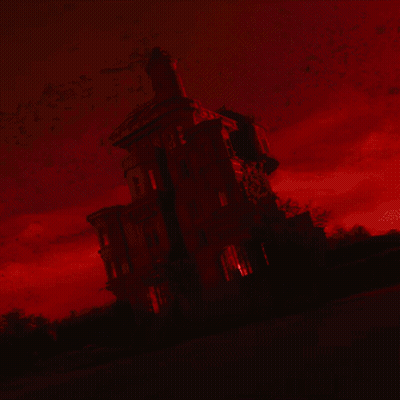 Man With Red Eyes Lying Upside Down In Dark Room GIF