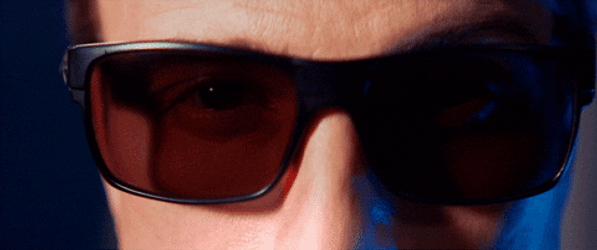 Man With Red Eyes Removing Eyeglasses GIF