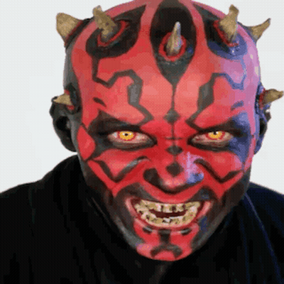 Man With Red Face Paint And Horns Smiling GIF