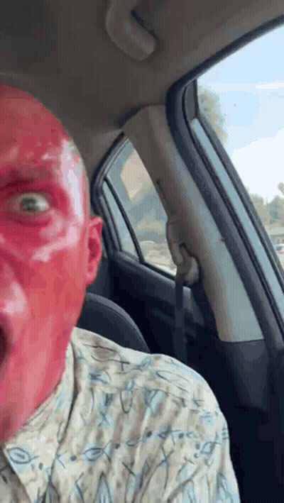 Man With Red Face Paint Sitting In Car GIF