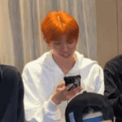 Man With Red Hair Holding Cell Phone GIF