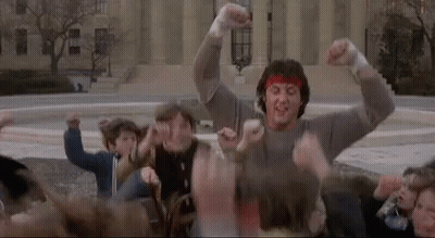 Man With Red Headband Surrounded By Crowd GIF