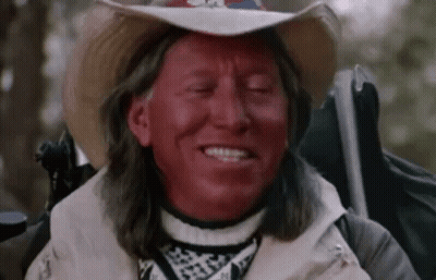 Man With Red Paint, Cowboy Hat, And Backpack GIF