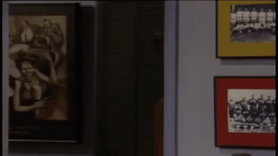 Man With Red Paint On Face By Picture Wall GIF