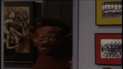 Man With Red Paint On Face Facing Picture Wall GIF