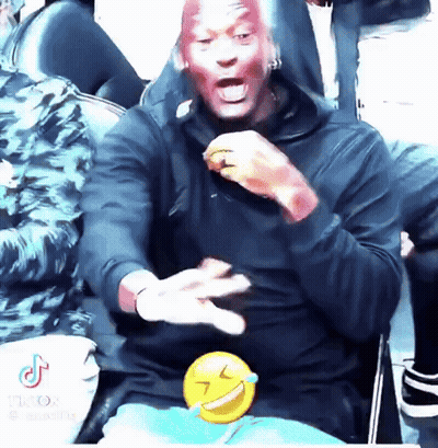 Man With Red Paint Sitting With Smiley Behind GIF