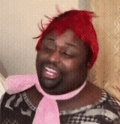 Man With Red Wig And Pink Scarf Smiling GIF