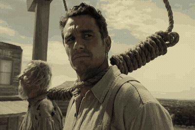 Man With Rope Around Neck Standing In Front Of Building Saying The GIF