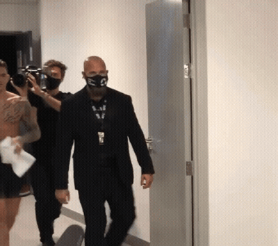 Man With S Mask Walking Hallway
