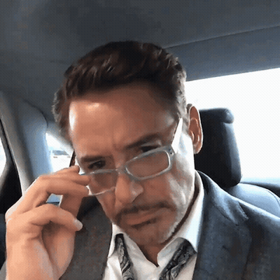 Man With Sarcastic Smile Looking At Another Man GIF