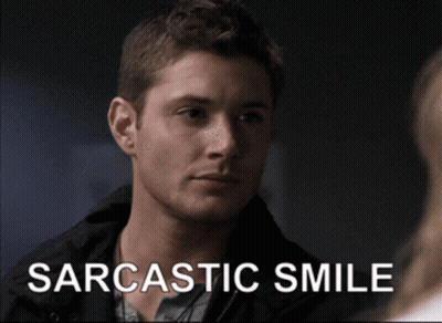 Man With Sarcastic Smile Looking At Another Man GIF