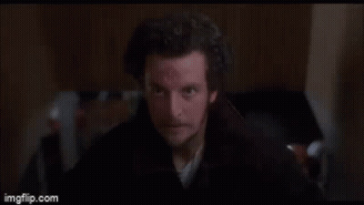 Man With Scar Standing In Dark Room GIF