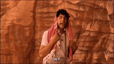 Man With Scarf Around Head Saying Hey GIF