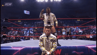 Man With Scarf At All Elite Wrestling Sign GIF