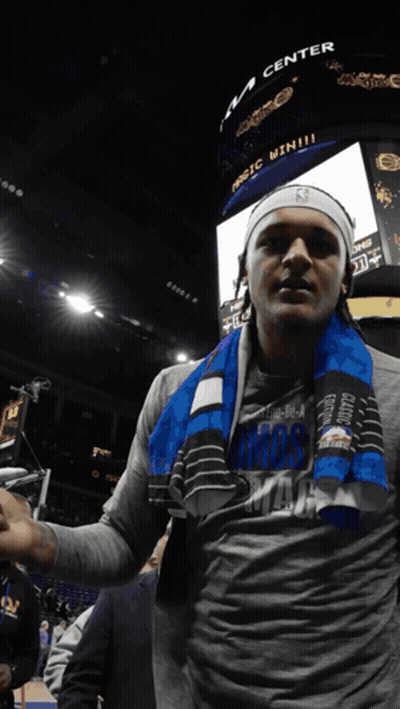 Man With Scarf In Front Of Magic Win Scoreboard GIF
