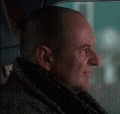 Man With Scarf Looking Out Window GIF