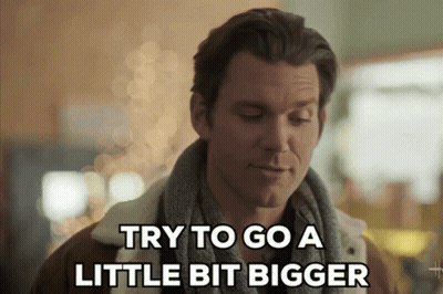 Man With Scarf Saying Try To Go A Little Bit Bigger GIF