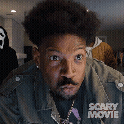 Man With Scary Movie Poster On Jacket GIF