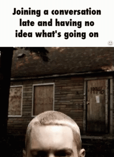 Man With Shaved Head In Front Of Graffiti GIF