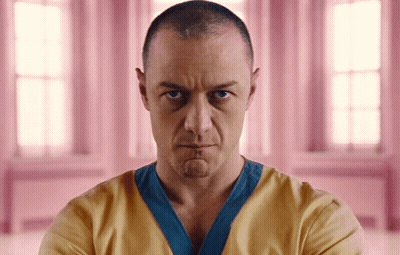 Man With Shaved Head In Yellow And Blue Shirt GIF