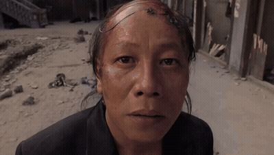 Man With Shaved Head Looking At Camera GIF