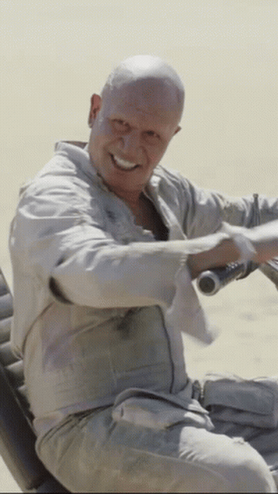 Man With Shaved Head Smiling Holding Steering Wheel GIF