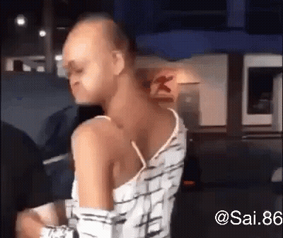 Man With Shaved Head Standing In Front Of Restaurant GIF