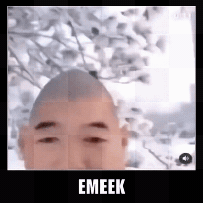 Man With Shaved Head Standing In Front Of Tree GIF