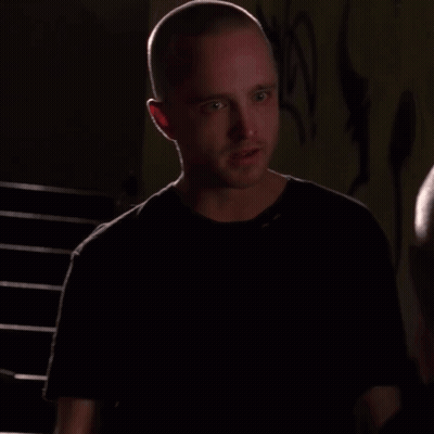 Man With Shaved Head Talking To Another Man GIF