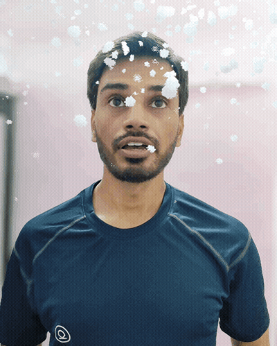 Man With Snowflakes On Face In Blue Shirt GIF