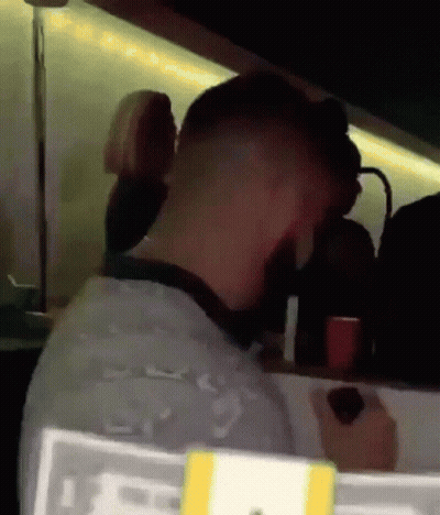 Man With Sorry Sign In Dark Room GIF