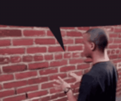 Man with Speech Bubble at Red Brick Wall