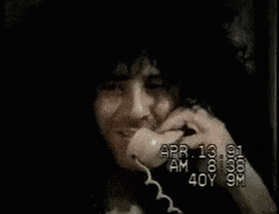 Man With Stack Of Money On Head Talking On Cell Phone GIF