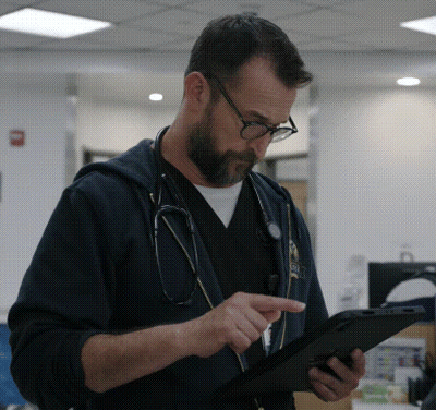 Man With Stethoscope Looking At Tablet GIF