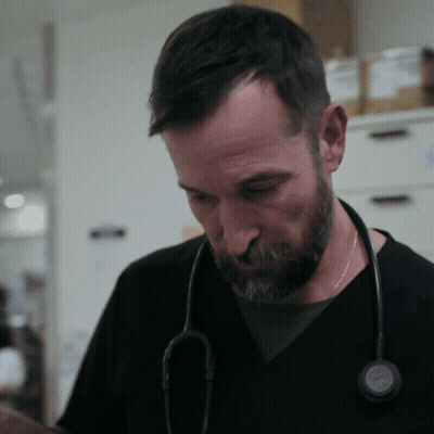 Man With Stethoscope Looking Down GIF