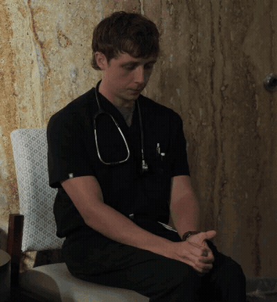 Man With Stethoscope Sitting Hands Folded