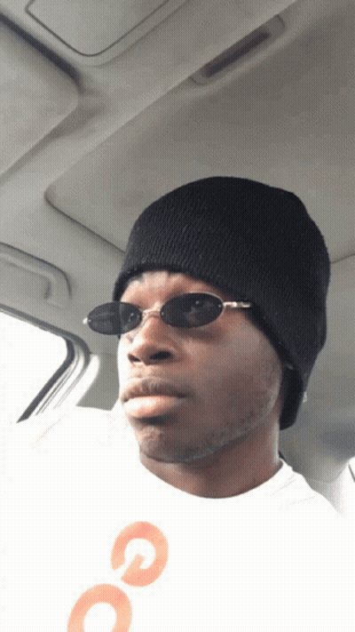 Man With Sunglasses And Beanie In Back Seat GIF