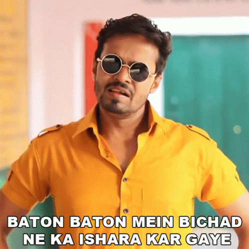 Man With Sunglasses Baton Baton Mein Bichad Ne Ka Ishara Kar Gaya GIF