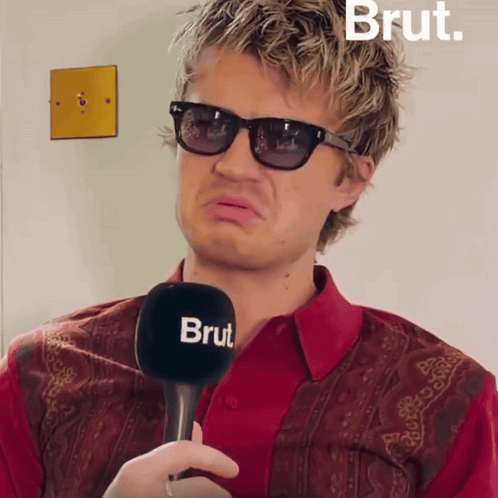Man With Sunglasses Holding Microphone Saying Brut GIF