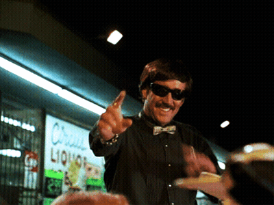 Man With Sunglasses In Front Of Liquor Store GIF