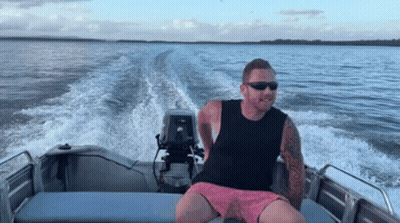Man With Sunglasses Sitting On Boat GIF