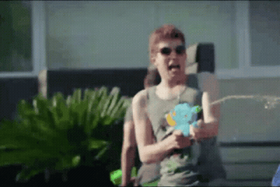 Man With Sunglasses Spraying Water Gun GIF
