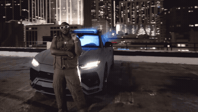 Man With Sunglasses Standing By Car In Parking Lot GIF