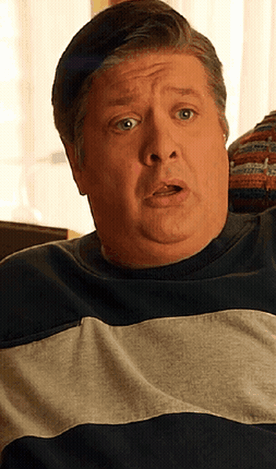 Man With Surprised Look In Striped Sweater GIF