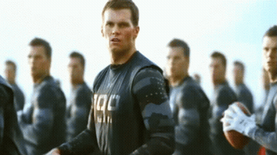 Man With Tac Shirt And Group Of Men GIF