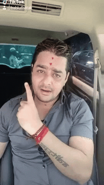 Man With Tattoo Giving Thumbs Up In Car GIF
